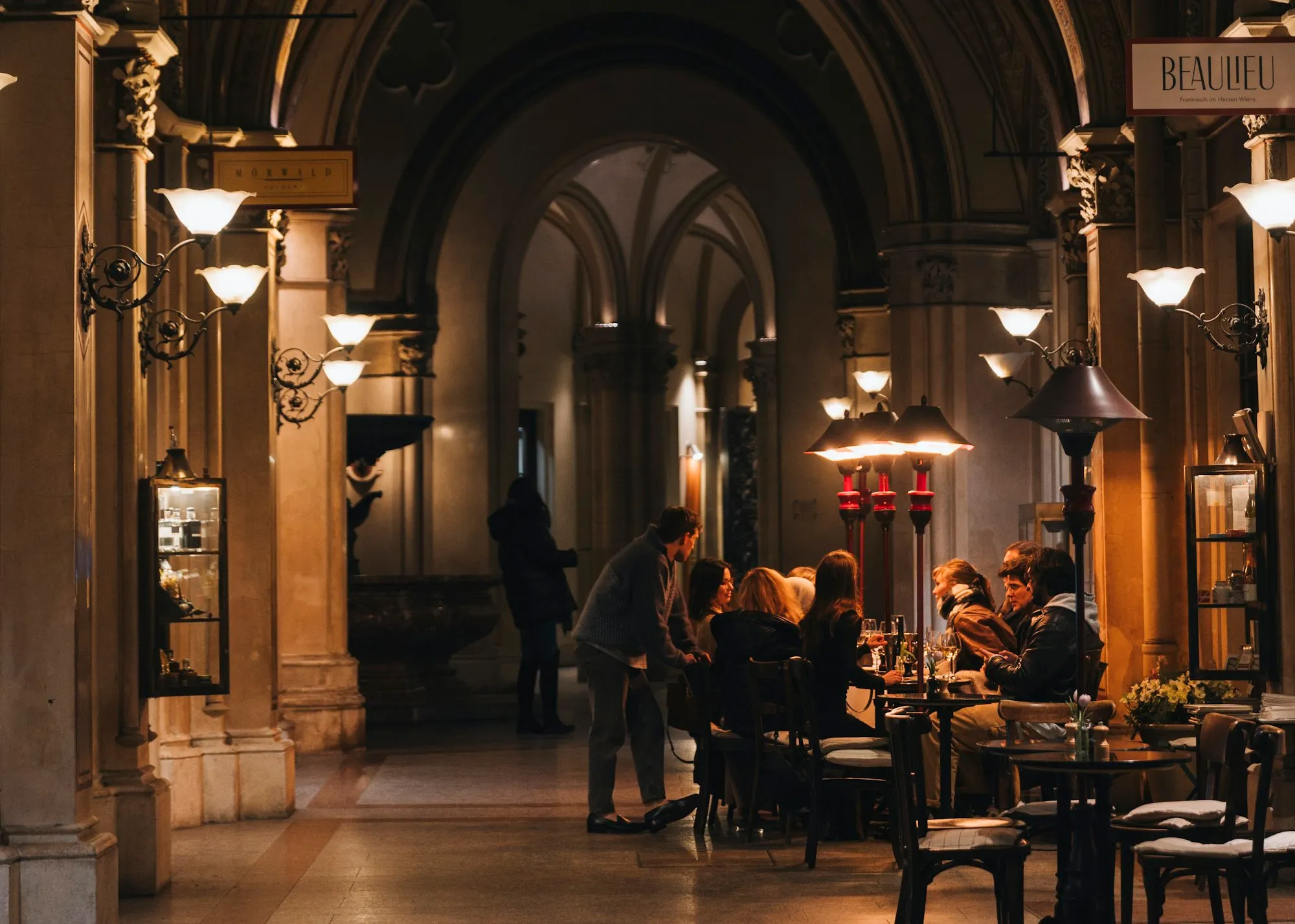 Candlelit dining under old stone arches