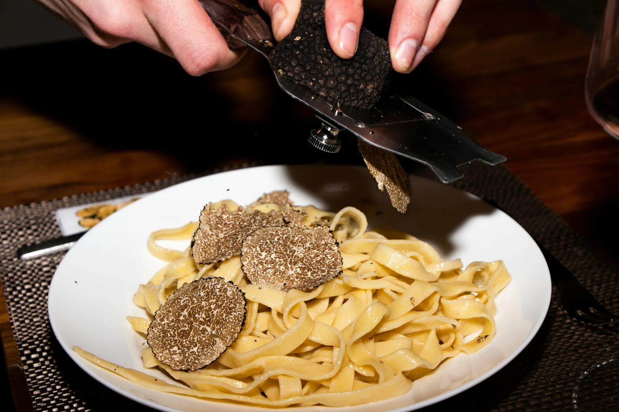 Black truffle shaved over fresh tagliatelle